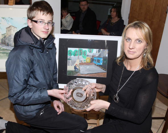 Heraldas Vaivada, a pupil of Scoil Mhuire, Kanturk, overall winner of the Schools Art Competition at the Kanturk Arts Festival receives his prize from Derval Fitzpatrick, Chairman, Kanturk Credit Union, sponsors of the competition. Photo by Patrick Casey